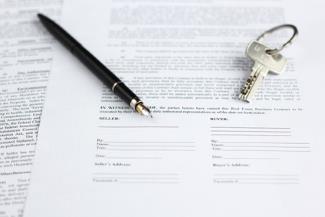 Picture of mortgage document, key and pen